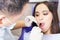 Dentist doctor treats teeth patient girl in dental office