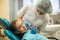 Dentist doing teeth checkup of little girl