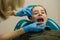 Dentist doing teeth checkup of little girl