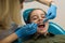 Dentist doing teeth checkup of little girl. Medicine.