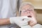 Dentist in exam room fitting dentures on woman