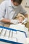 Dentist in exam room with young boy in chair