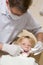 Dentist in exam room with young boy in chair