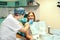 Dentist examine female patient with braces in denal office.