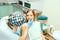 Dentist examine female patient with braces in denal office.