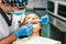 Dentist examine female patient with braces in denal office.