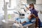 Dentist examine girl`s teeth