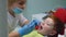 Dentist examines baby teeth. Pediatric dentistry