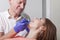 Dentist examines gums and teeth of his female patient