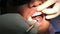 Dentist examines oral cavity and patient\'s teeth using dental mirror closeup.