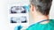 The dentist examines a panoramic X-ray image of the teeth of the upper and lower jaws. Preparation for dental implantation. The