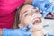 A dentist examines a patient, close-up of a patient with an open mouth next to which dental objects