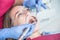 A dentist examines a patient, close-up of a patient with an open mouth next to which dental objects