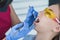 A dentist examines a patient, close-up of a patient with an open mouth next to which dental objects. The concept of
