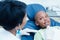 Dentist examining boys teeth in dentists chair