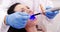 Dentist examining female patient with dental curing light