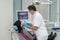 Dentist examining patient`s teeth with intraoral camera