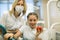 Dentist female gives apple for smiling teenage girl