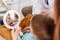 Dentist fixing tooth to a little boy