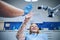 Dentist giving high-five to girl in modern dental surgery