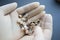 Dentist hands holding dentures and crowns closeup