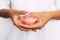 The dentist is holding dentures in his hands. Dental prosthesis in the hands of the doctor close-up. Front view of complete