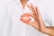 The dentist is holding dentures in his hands. Dental prosthesis in the hands of the doctor close-up. Front view of complete