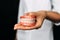 The dentist is holding dentures in his hands. Dental prosthesis in the hands of the doctor close-up. Front view of complete