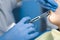 Dentist injects anesthesia syringe of the diseased teeth for the patient. Caries treatment.