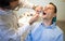 Dentist Inspecting Teeth Of Young Man.