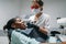 Dentist installs the seal on tooth, dental clinic