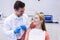 Dentist interacting with female patient while examining