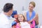 Dentist interacting with young patient