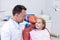 Dentist interacting with young patient