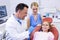 Dentist interacting with young patient