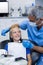 Dentist interacting with young patient while examining