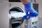 Dentist loading steel dental instruments sealed in separate airtight packaging in a steam autoclave for sterilization