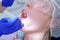 Dentist make fluoridation of teeth after ultrasonic cleaning for young woman.
