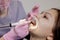 Dentist making professional teeth cleaning female young patient at the dental office. Close-up plan