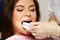 Dentist making teeth whitening procedure