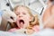 Dentist with mirror examines teeth of girl