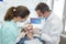 Dentist and nurse curing female patient