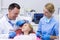 Dentist and nurse interacting with a young patient