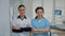 Dentist and nurse in medical uniform standing at dental clinic