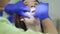 Dentist preparing patient oral cavity for teeth whitening procedure