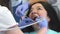 Dentist provides oral irrigation for client