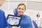 Dentist with x-ray on tablet pc and girl patient