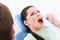 Dentist rinses the oral cavity of the patient