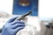 Dentist`s hand in Blue gloves working with handpiece in dental ofice