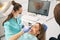 Dentist scanning woman teeth with dental intraoral 3D scanner